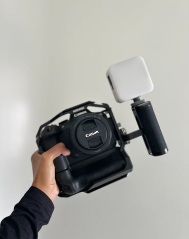 a person holding a camera and a camera