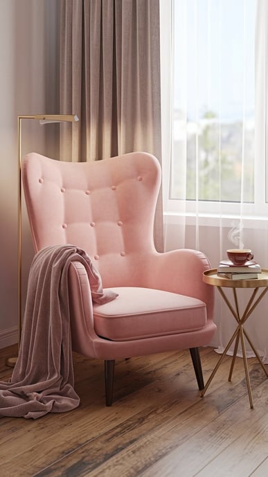 a pink armchair with a plush throw blanket draped on it