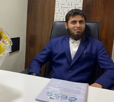 Director of CESS Consultants Sitting at office Desk