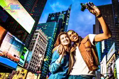 a man and woman taking a selfie in the city