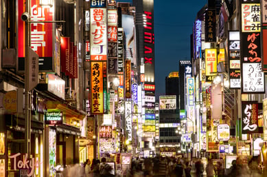 a busy street with many signs in Tokyo