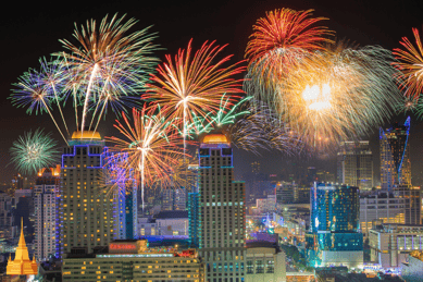 a city skyline with fireworks in the background
