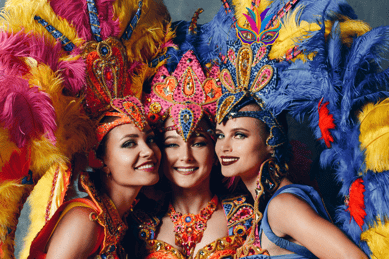 three women in colorful costumes posing for a photo