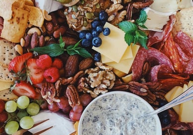 a platter of fruit and nuts on a platter