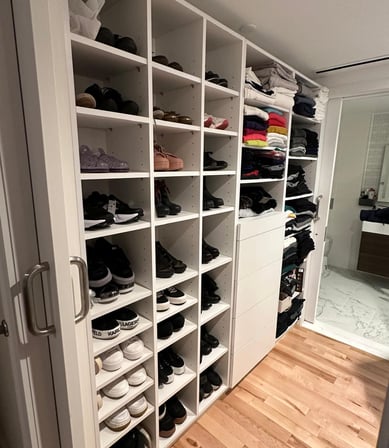 a closet with a lot of shoes and a door
