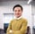 a man in a yellow sweater and a white shirt