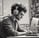 man sitting at computer with headphones on