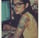 a woman with tattoos on her arm and a laptop