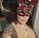 a woman in a leopard print dress and a mask