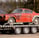 a car is being towed down a flatbed trailer
