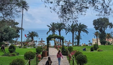 a woman walking down a path with a child