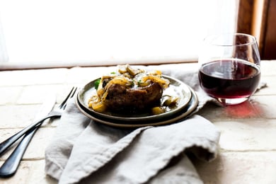 a plate of food with a glass of wine