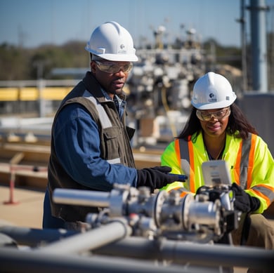 NexOp in safety gear standing in front of a large pipe