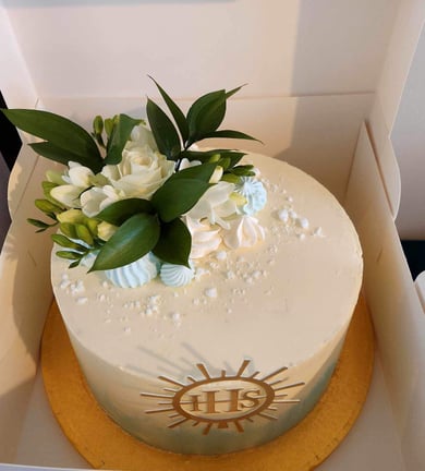 a cake with white flowers in a box