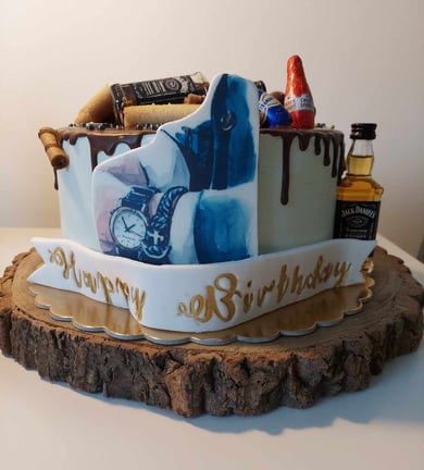 a birthday cake with a cake on top of a wooden table