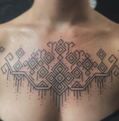 An handpoke tattoo featuring art ornaments tappis geomatric symmatrical lines inspired, 