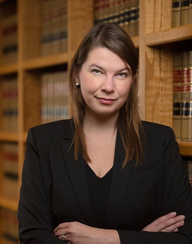 a woman in a suit and a suit jacket in a library