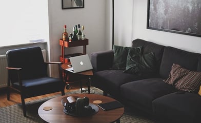 Bright living room with laptop on table