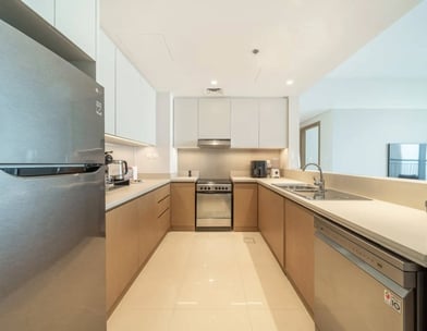 a kitchen with a refrigerator, stove
