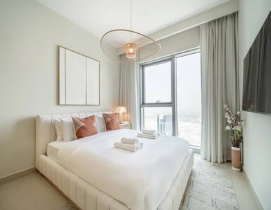 a bedroom with a bed and a television