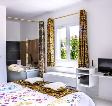 Bedroom with bathroom and toilet, television, air conditioner and pool view at Domaine Des Lucques