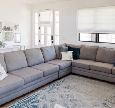 a living room with a couch and a rug