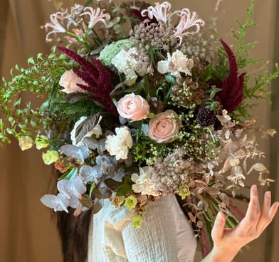 a woman with a wild flower bouquet