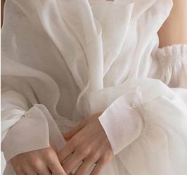 a woman in a flowing silk dress