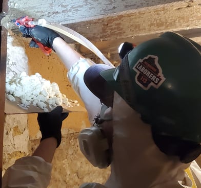 Energy assessor insulates rim joists and sealing gaps to stop energy loss