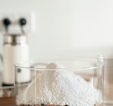 Premium Australian Skim Milk Powder in a clear container, showcasing its fine, white texture