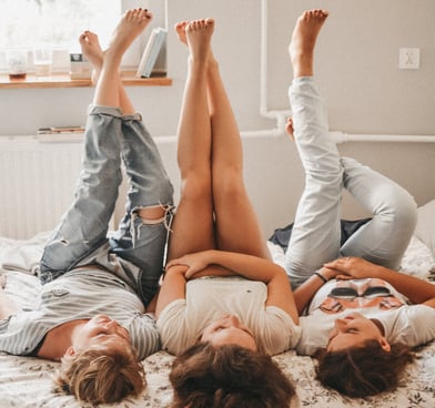 a couple of people laying on a bed