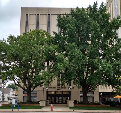 Lakewood Center West building partially obscured by trees