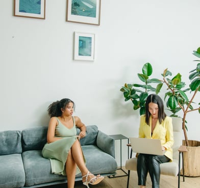 Two women who are seated having a conversation