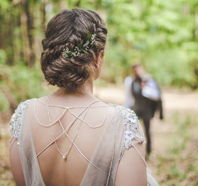 Natural wedding updo with fishtail braids and low bun