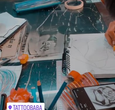A close-up of a detailed tattoo being inked at Tattoo Baba, showcasing the artist's precision and sk