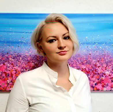 a woman in a white shirt and a painting of a flower