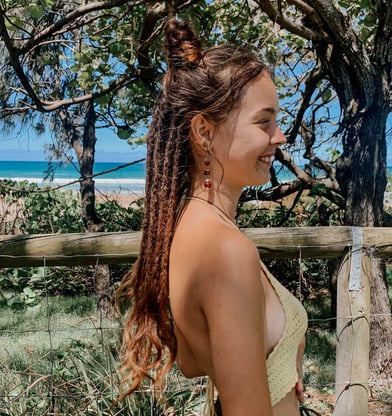 a woman at the beach with dreadlocks