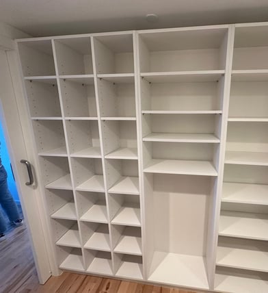 a closet with a closet door open and a person standing in front of it