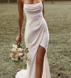 a woman in a white dress with a bouquet of flowers
