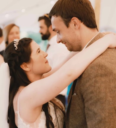 bride and groom smiling at each other during their first dance