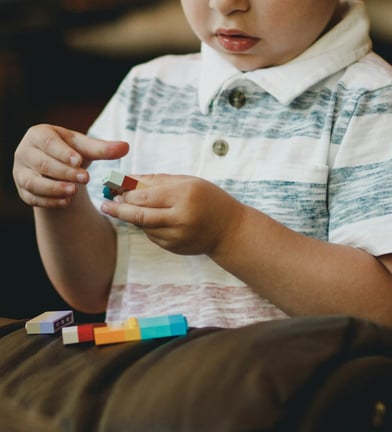 a young boy playing with blocks and blocks