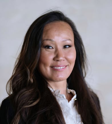 Porträtt på Jiang med utsläppt hår. Hon står något vriden åt höger. Hon ler. Håret är svart och utsläppt