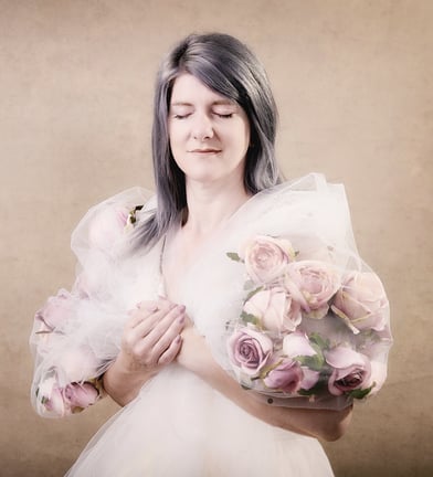 Photograph of a beautiful woman wearing a flower cape