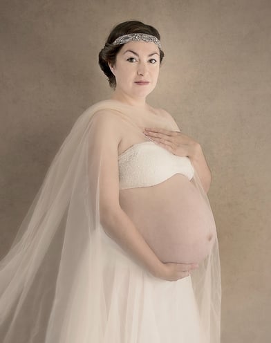 Photograph of a beautiful pregnant woman with a russion headband