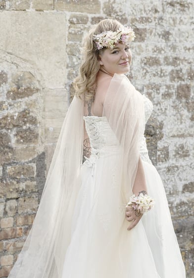 Image of a bride in front of a stone wall