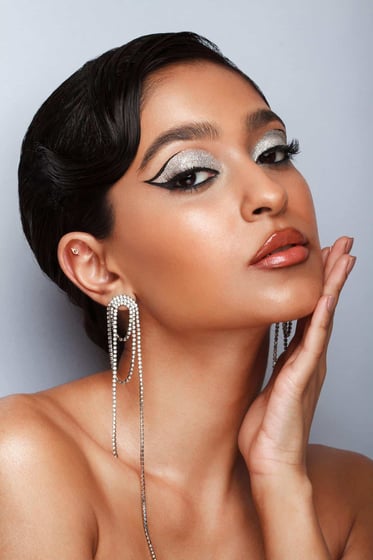 fashion portrait of makeup artist Zahra Omarji with glitter makeup