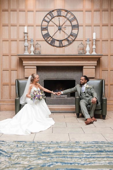 Newly weds hold hands in a beautiful wedding portrait