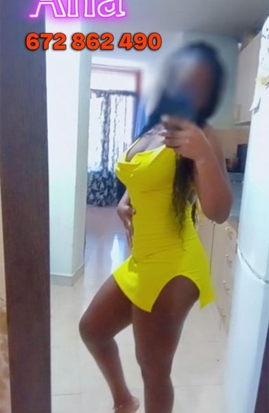 a woman in a yellow dress is taking a selfie