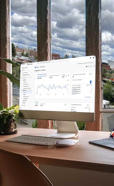 Campaign analytics on a computer screen with an office view of Spokane, WA.