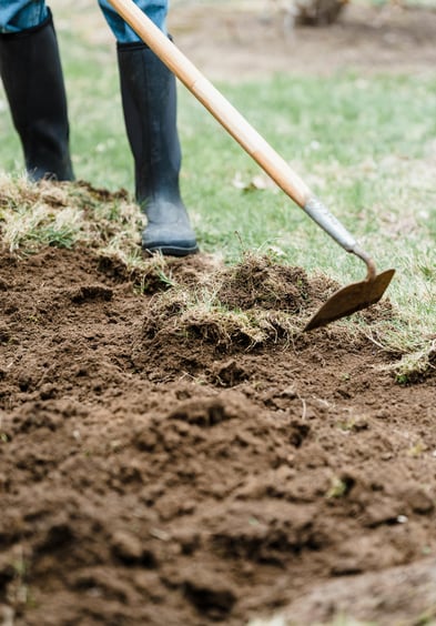 a gardener woring with a hoe